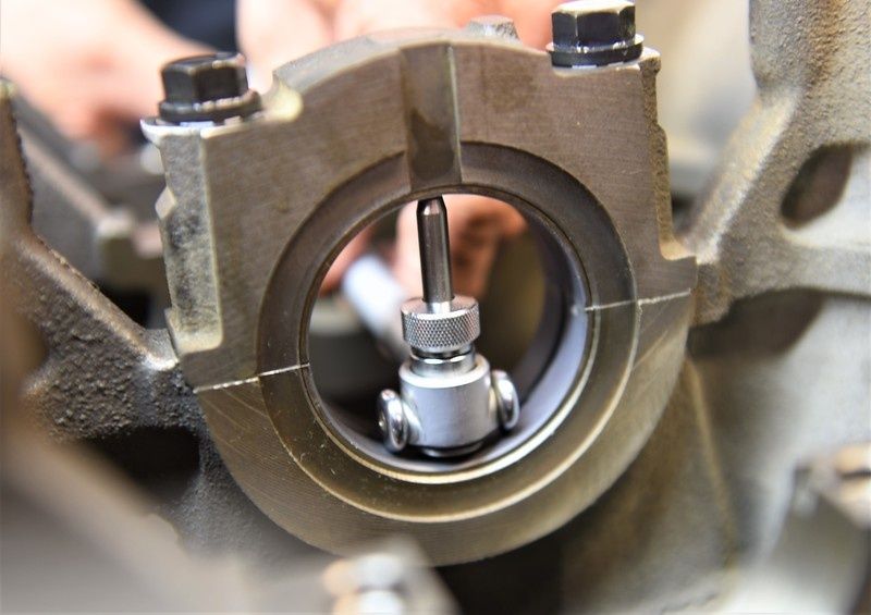 Dial bore gauge positioned inside an engine bearing housing