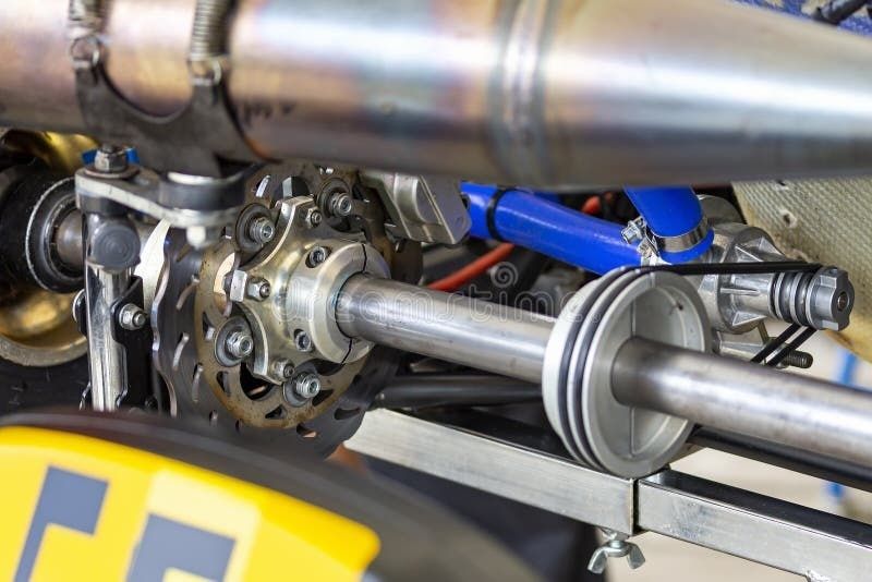 Close-up of a race car front suspension spindle and steering components